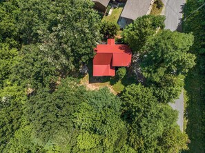 An aerial view of a red-roofed building surrounded by dense green trees. - Escape to Firefly Ridge in Sevierville and discover your perfect Tennessee mount (Sevierville)