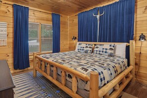 Cozy log cabin bedroom with rustic cedar frame, soft blue plaid linens, and warm wood paneling—your peaceful retreat awaits after days spent exploring. - Escape to Firefly Ridge in Sevierville and discover your perfect Tennessee mount (Sevierville)