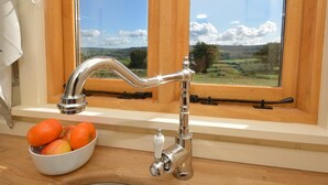 A kitchen with a window, a sink, and a bowl of fruit. - 1 Bed in Usk- (oc-63292) (Llangwm)