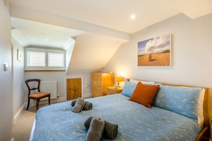 A bedroom with a bed, a chair, a dresser, and a painting on the wall. - 3 Bed in Wells-next-the-sea (oc-kt050) (Wells-next-the-Sea)