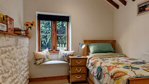 A bedroom with a window, a bed, a nightstand, and a wall-mounted shelf with books and a potted plant. - 2 Bed in Thorpe Market (oc-kt107) (Thorpe Market)