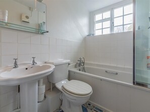 A bathroom with a sink, toilet, bathtub, and a window. - 2 Bed in North Creake (oc-kt003) (North Creake)