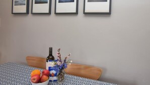 A room with a bed, a table with a bowl of fruit, a bottle, and a vase with flowers. - 3 Bed in Kettlestone (oc-kt037) (Little Snoring)