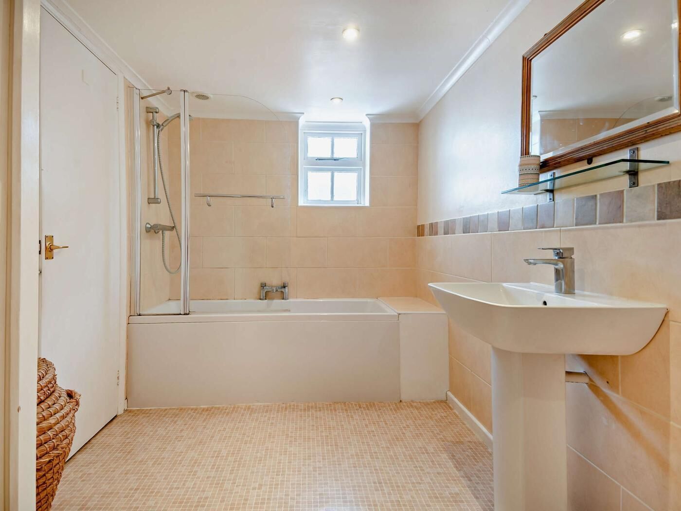 A bathroom with a bathtub, a sink, and a shower.