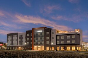 A modern hotel with a prominent CAMBRIA sign, multiple floors, and a well-lit facade. - Cambria Hotel Colorado Springs - Air Force Academy (Colorado Springs)