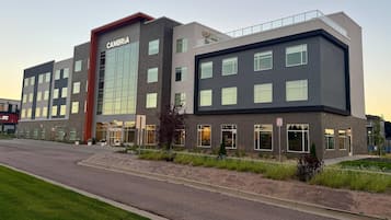 A modern building with a prominent sign reading 'CAMBRIA' and a fire lane sign.