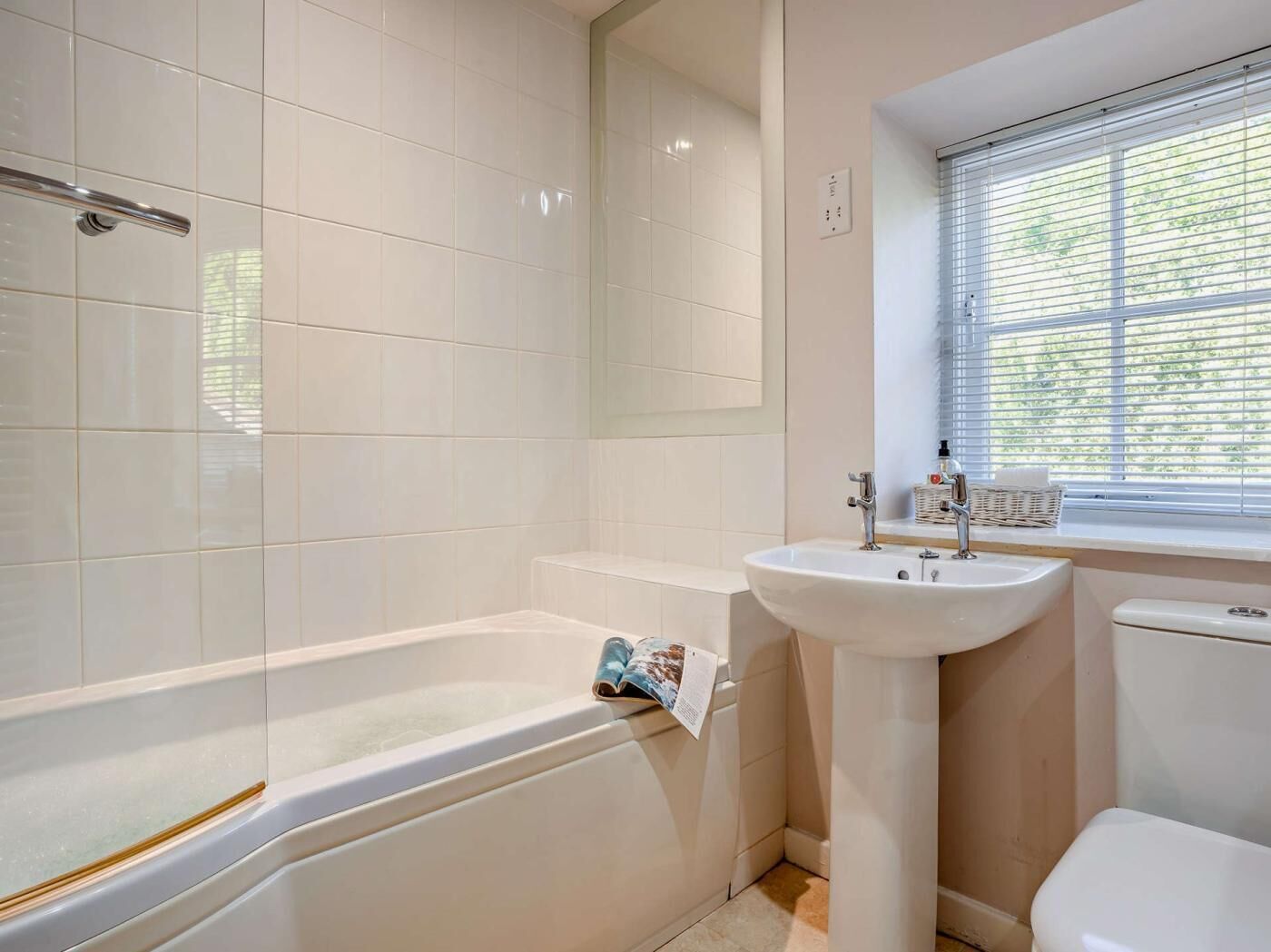 A bathroom with a bathtub, a sink, and a toilet.