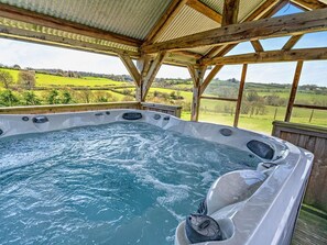 A hot tub with a wooden deck and a view of green fields. - 1 Bed in Narberth (oc-72863) (Whitland)