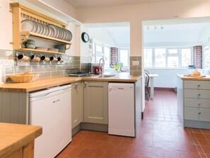 A kitchen with a dishwasher, a sink, and a window. - 3 Bed in Harrogate (oc-hh057) (Harrogate)