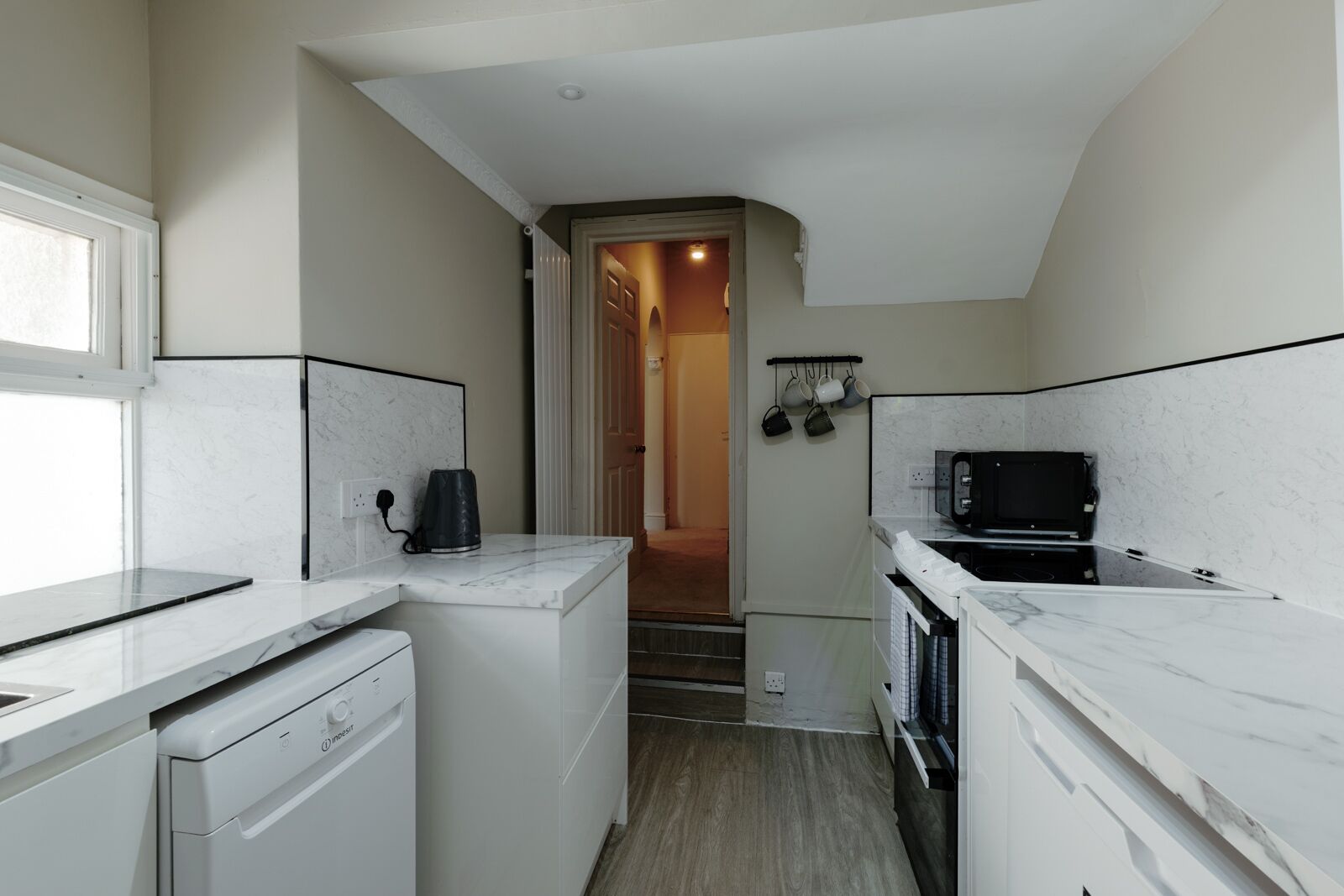 Fully equipped kitchen featuring a dishwasher, washer and dryer