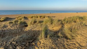 A beach with sand dunes and a clear sky. - 4 Bed in Old Hunstanton (oc-kt169) (Hunstanton)