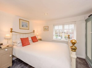 A neatly arranged bedroom with a bed, bedside tables, and a window with blinds. - 1 Bed in Tenterden (oc-66342) (Tenterden)
