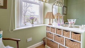 A room with a window, wicker baskets, a lamp, and a mirror. - 2 Bed in Newcastle Upon Tyne (oc-66305) (Otterburn)