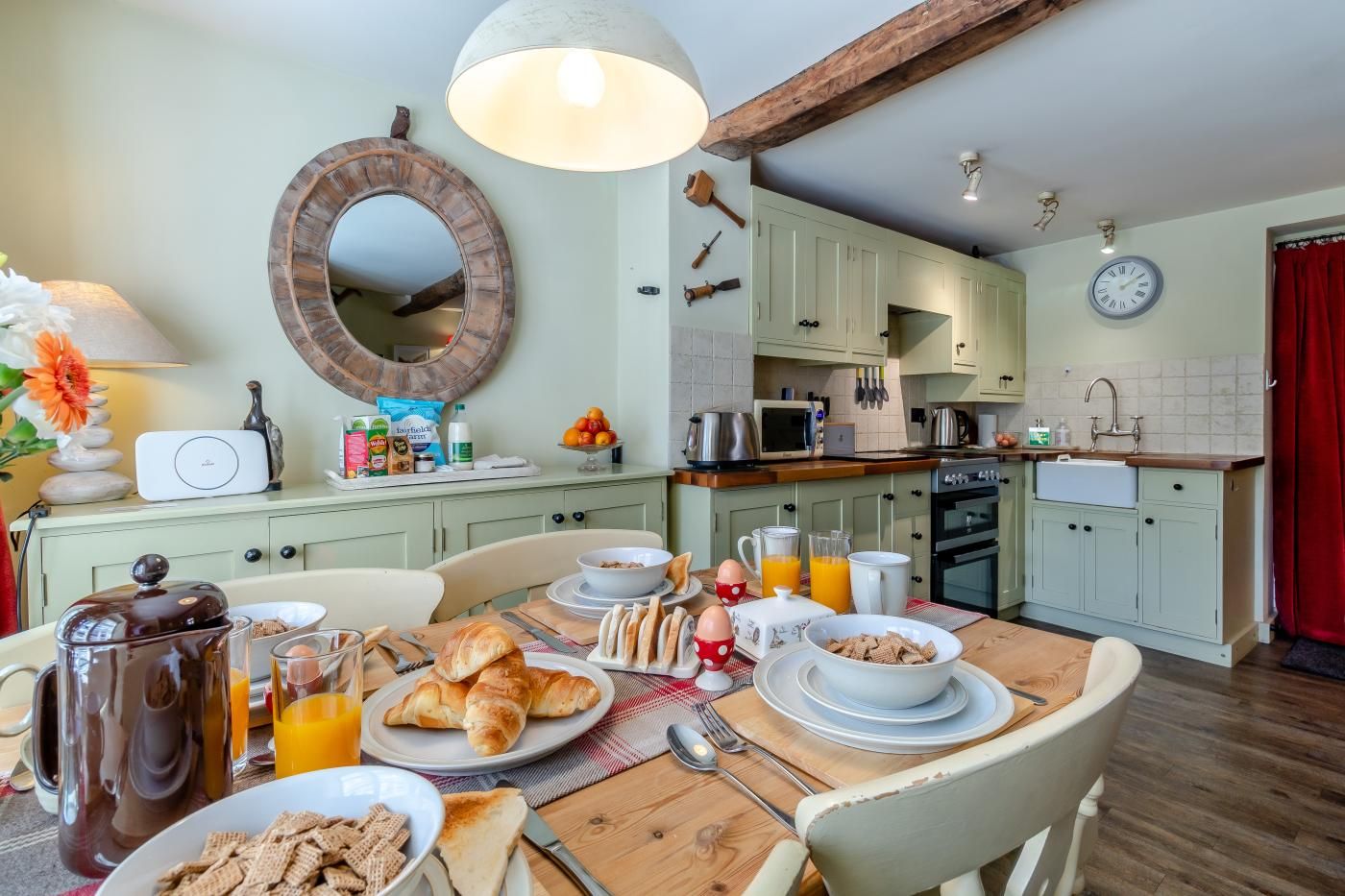 A well-equipped kitchen with modern appliances, a dining table set for breakfast, and a cozy atmosphere.