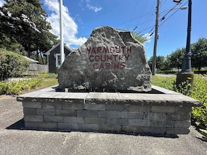 A stone monument with the inscription 'YARMOUTH COUNTRY CABINS' on a paved area with a brick base. - Two  Bedroom Cabin PLUS one bedroom guest cabin (Yarmouth)