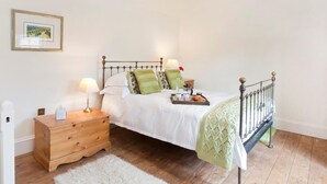 A bedroom with a bed, bedside table, lamp, dresser, and a hanging light fixture. - 1 Bed in York (oc-g0043) (Holtby)