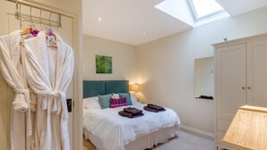 A hotel room with a bed, a wardrobe, a skylight, and a bedside table. - 1 Bed in York (oc-g0032) (Crayke)