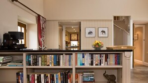 A home library with bookshelves, a coffee machine, and framed pictures on the wall. - 1 Bed in Ripley (oc-g0127) (Kirkby Malzeard)