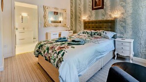 A bedroom with a bed, a nightstand, a dresser, a mirror, and a door leading to another room. - 1 Bed in Pickering (oc-g0120) (Rosedale Abbey)