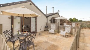 A patio with a table and chairs, a covered seating area, and a view of the surrounding landscape. - 1 Bed in Taunton (oc-74145) (Williton)