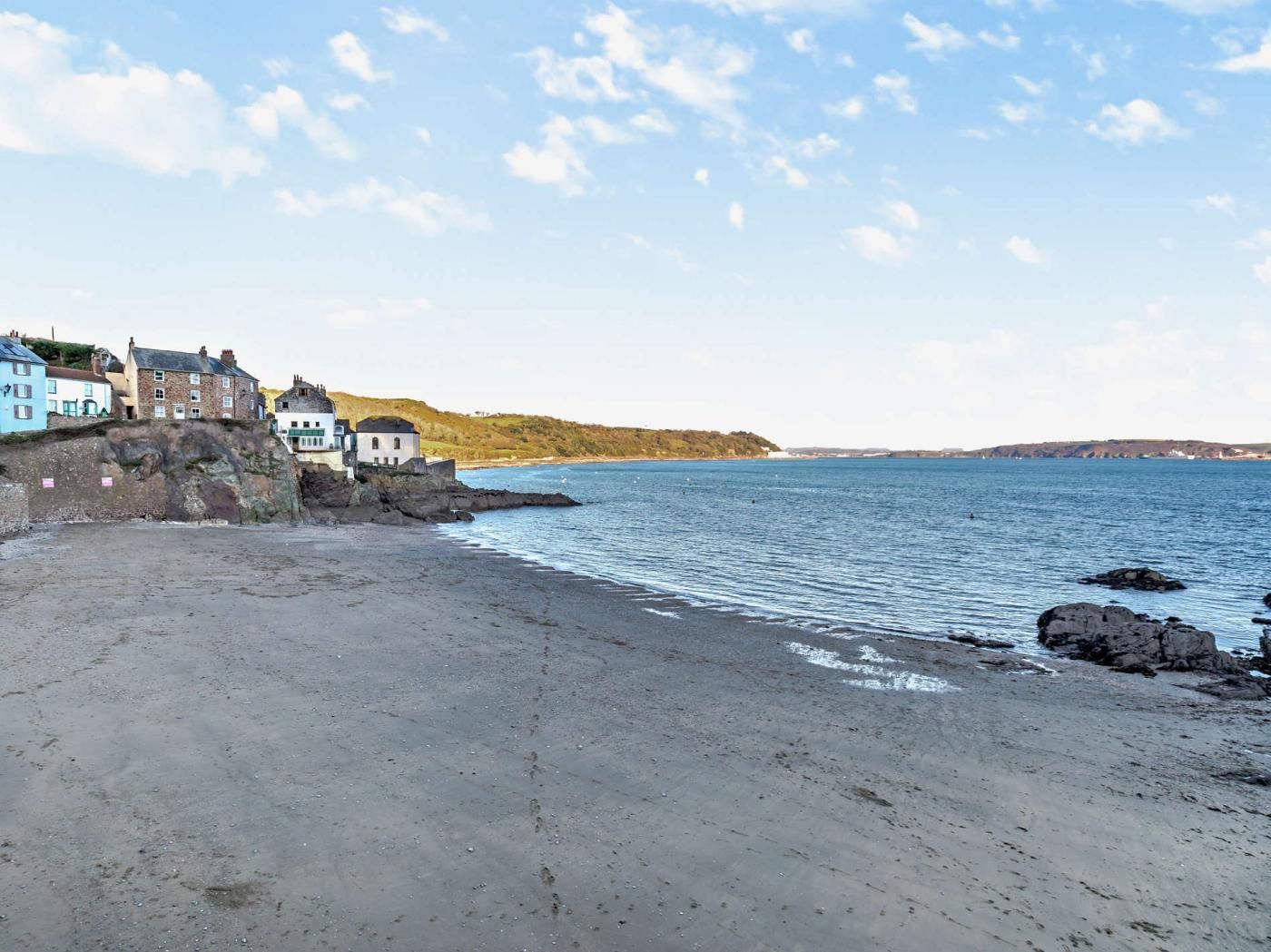 A coastal scene with buildings on a cliff overlooking the sea.