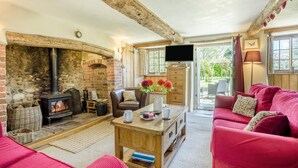 A cozy living room with a fireplace, a television, and comfortable seating. - 3 Bed in Dorchester (oc-dc008) (Chaldon Herring)