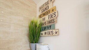A bathroom with a wall-mounted sign, a potted plant, a white basin, and a stone with 'Brush & Wash' engraved. - 1 Bed in Darlington (oc-75147) (Stapleton)