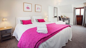 A bedroom with a large bed, a desk, a chair, a mirror, and two framed pictures on the wall. - 5 Bed in Worcester (oc-75602) (Halmond's Frome)