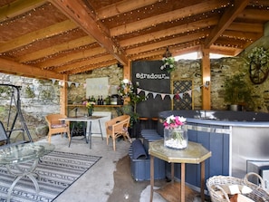 An outdoor seating area with a bar, stone walls, and string lights. - 1 Bed in Pitlochry (oc-75678) (Pitlochry)