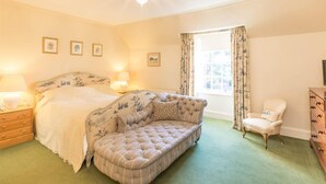 A bedroom with a bed, a sofa, a chair, a dresser, and a window with curtains. - 6 Bed in Fochabers (oc-ca102) (Fochabers)
