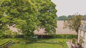 A well-maintained garden with a lawn, hedges, and a large tree. - 6 Bed in Fochabers (oc-ca102) (Fochabers)