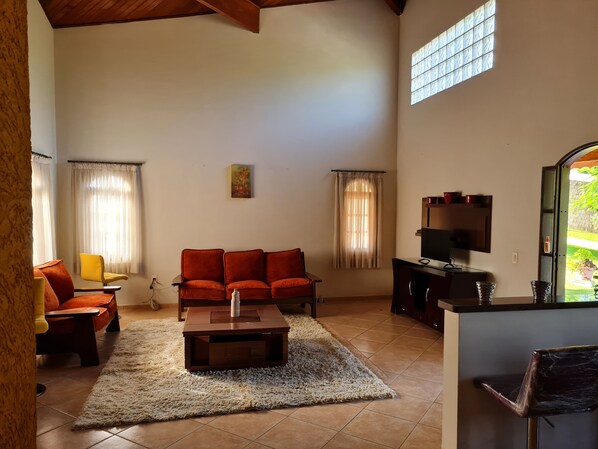 A living room with a sofa, coffee table, and TV stand.