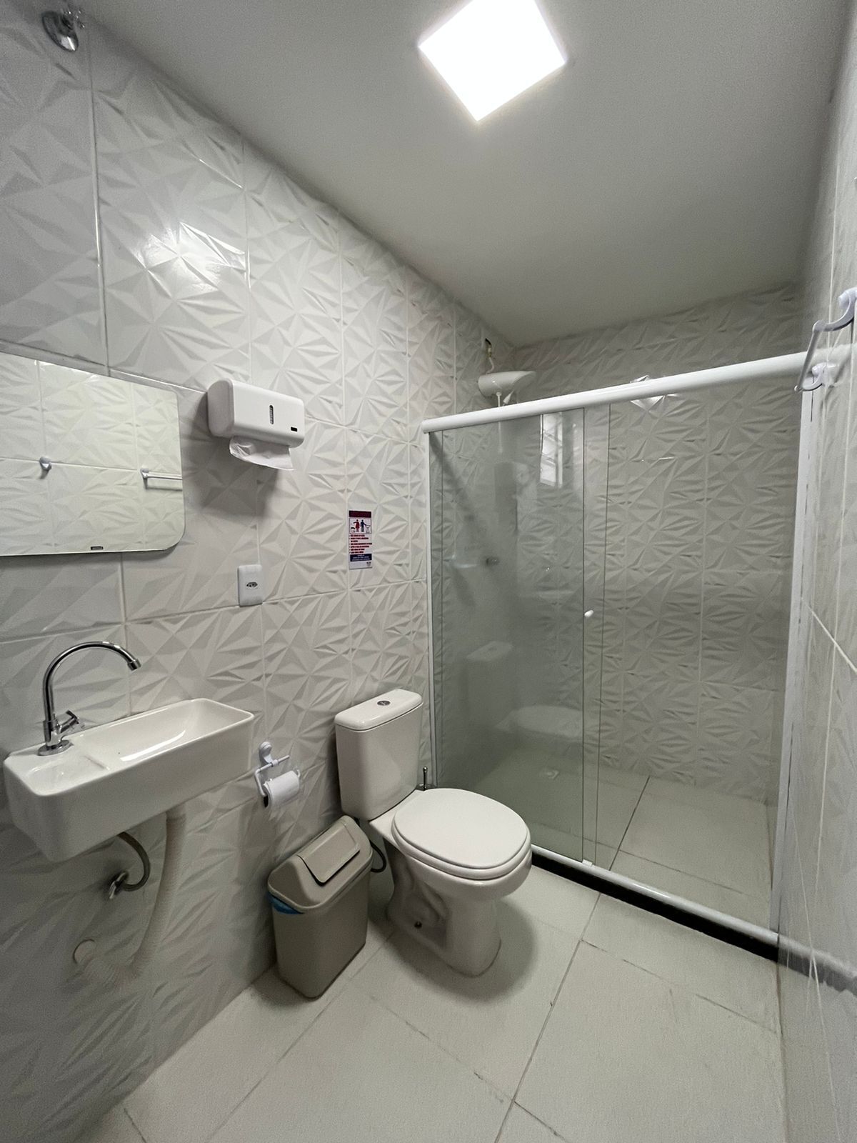 A bathroom with a sink, toilet, and shower.