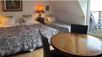 Triple Room, Balcony, City View | Individually furnished, bed sheets