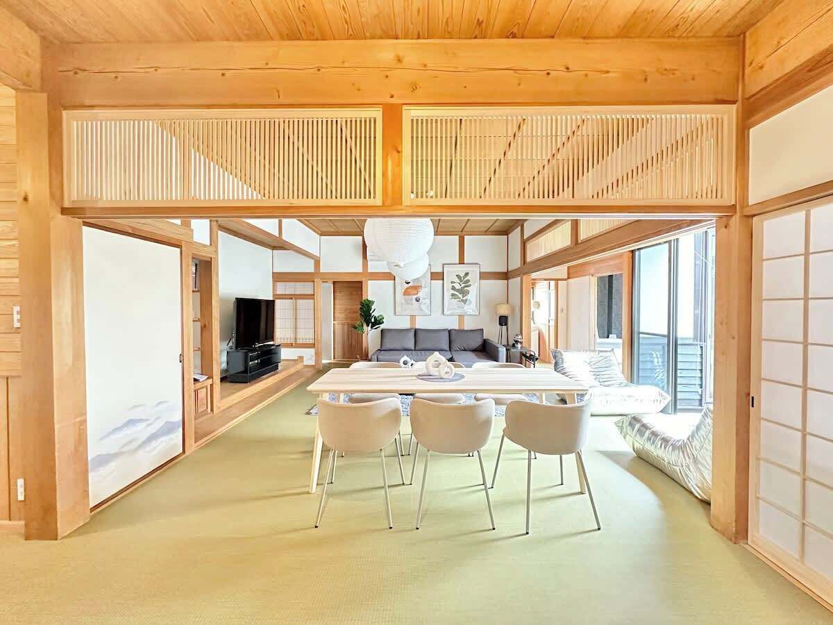 A spacious living area with a central island, a television, and a sofa.