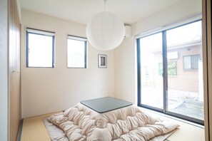 A room with a bed, a window, and a picture on the wall. - Otsu Hachibuko Homes By Restavio (Ozu)