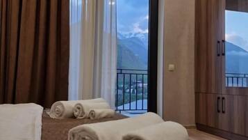 Panoramic Triple Room, Balcony, Mountain View | Desk, laptop workspace, bed sheets