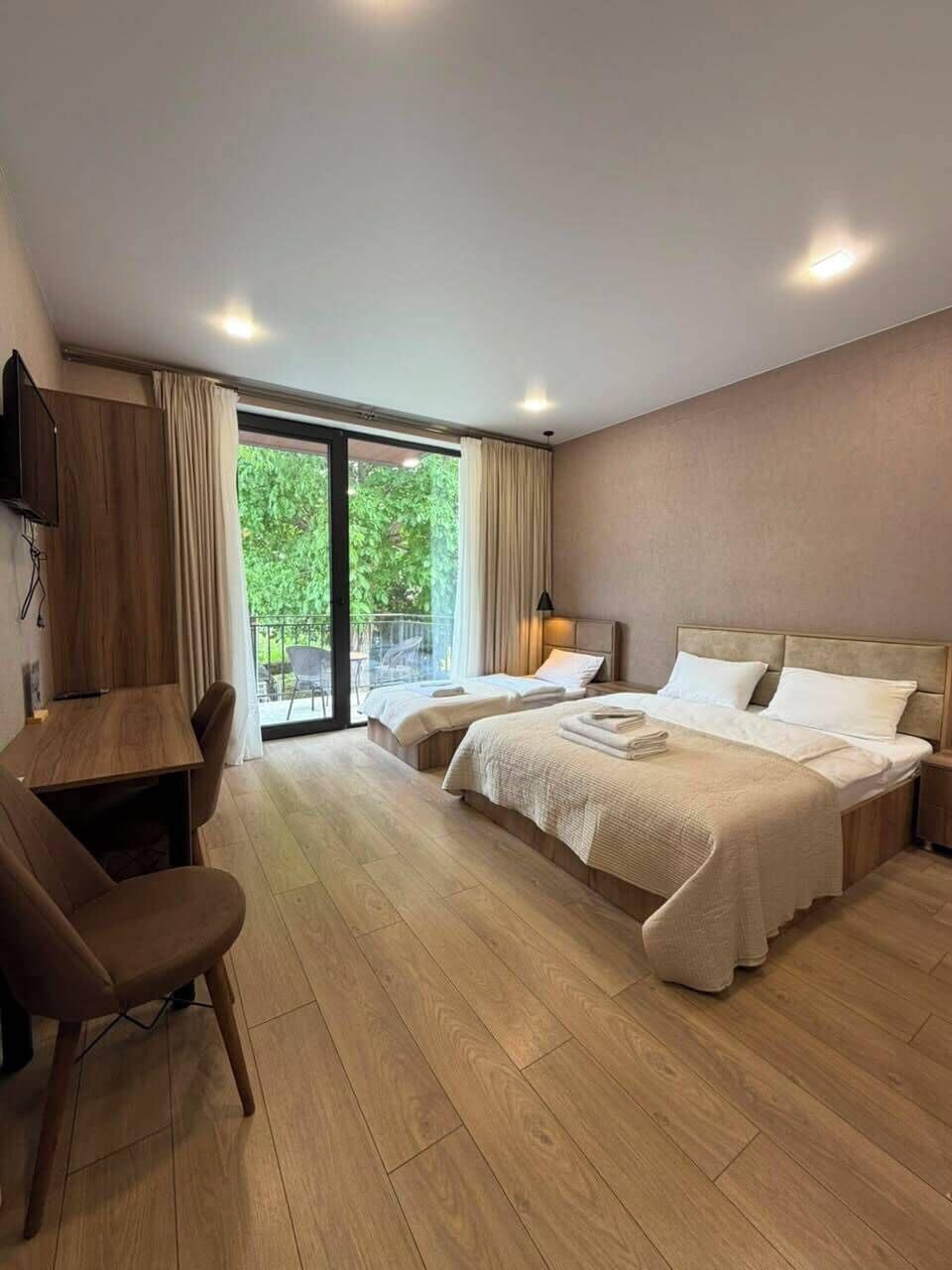 Comfort Triple Room, Balcony, City View | Desk, laptop workspace, bed sheets
