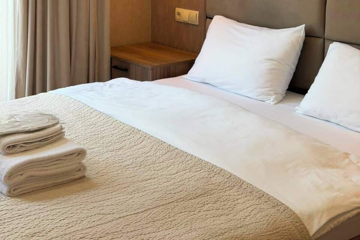 Desk, laptop workspace, bed sheets