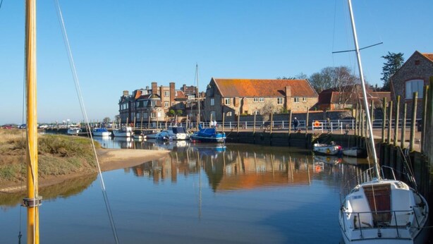 A calm harbor with boats, a stone building, and a clear sky. - 2 Bed in Holt (oc-ncc66) (Blakeney)