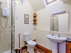 A bathroom with a shower, toilet, sink, and a wooden shelf with toiletries. - 1 Bed in Leighton (oc-80727) (Leighton)