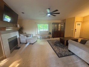 A living room with a fireplace, two sofas, a coffee table, and a ceiling fan. - The Ultimate Group Getaway/ 5 bedrooms and 3.5 bathrooms/ Sleeps 13+/ (Johnstown)