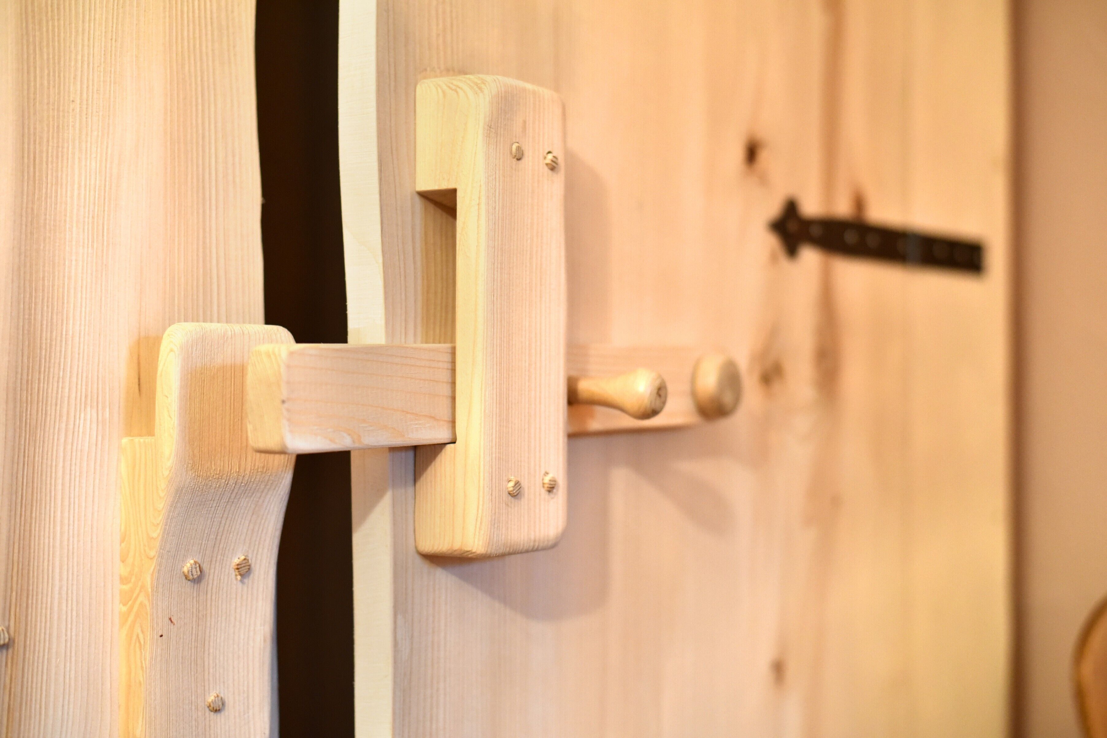 A wooden door with a simple latch mechanism.
