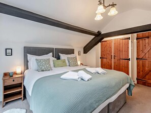 A bedroom with a bed, bedside table, lamp, and wooden wardrobe. - 2 Bed in Ambleside (oc-sz500) (Grasmere)