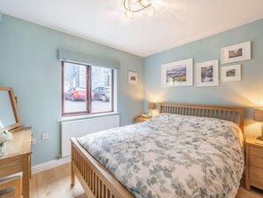 A bedroom with a bed, bedside tables, a window, and framed pictures on the wall. - 1 Bed in Keswick (oc-85419) (Keswick)