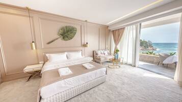 A bedroom with a large bed, a bedside table, a chair, a view of the ocean, and a large window.