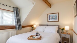 A bedroom with a bed, bedside tables, a radiator, a window with curtains, a picture on the wall, and a tray with breakfast items. - 5 Bed in York (oc-77267) (Green Hammerton)