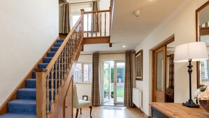 A staircase with wooden balusters, a chair, a wooden cabinet with drawers, and a lamp. - 5 Bed in York (oc-77267) (Green Hammerton)