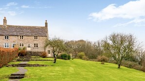 A stone building with a stone staircase leading to a door, surrounded by a well-maintained lawn and trees. - 4 Bed in Wareham (oc-78042) (Kingston)