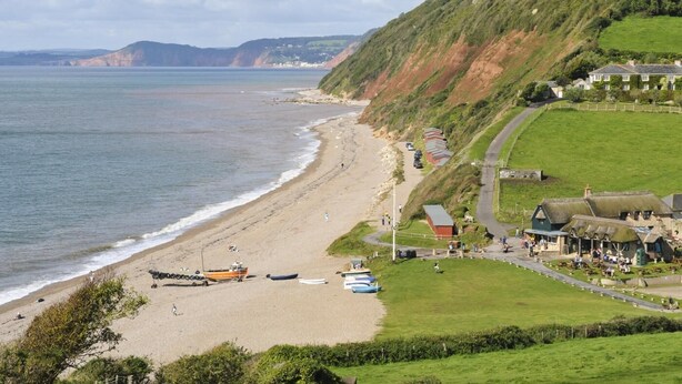 A coastal beach with a road leading to a row of houses. - 3 Bed in Branscombe (oc-78002) (Branscombe)